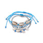 Lovra bracelet with blue and white beads and silver charm on a white background