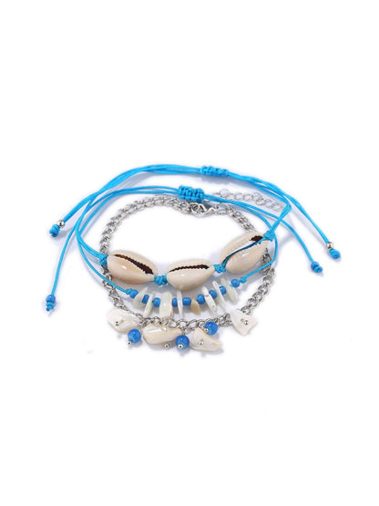 Lovra bracelet with blue and white beads and silver charm on a white background