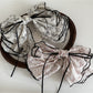 Close-up of Beau floral bow hair clip showing detailed pink and white flower design