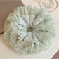 Close-up of mint green plaid tulle fabric and ruffle details on scrunchie