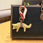 Fox charm keychain hanging on a decorative hook with other keychains