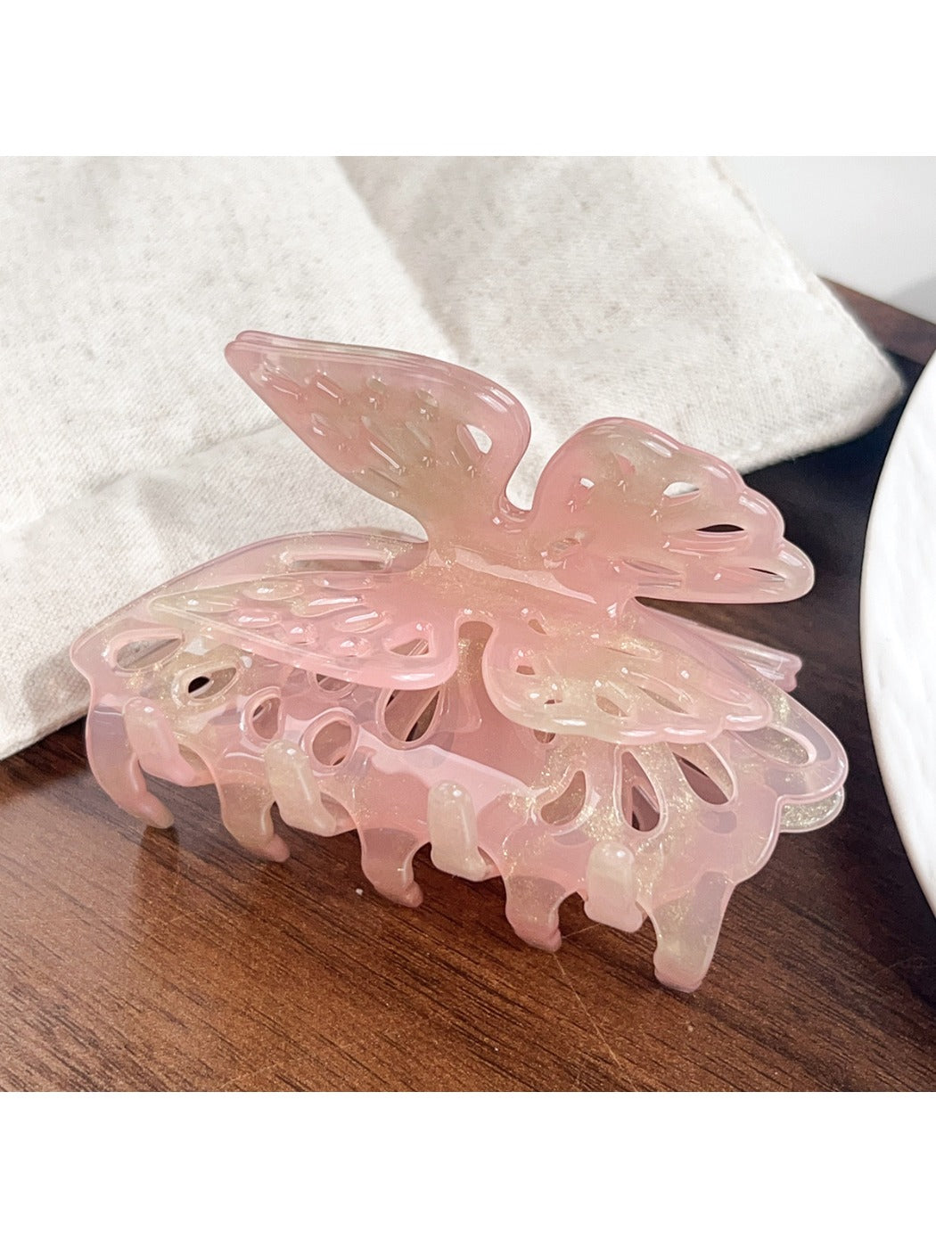 Beau butterfly hair claw clip worn in half-up hairstyle on model with dark hair