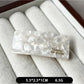 Beau curved bar hair clip resting on a marble countertop