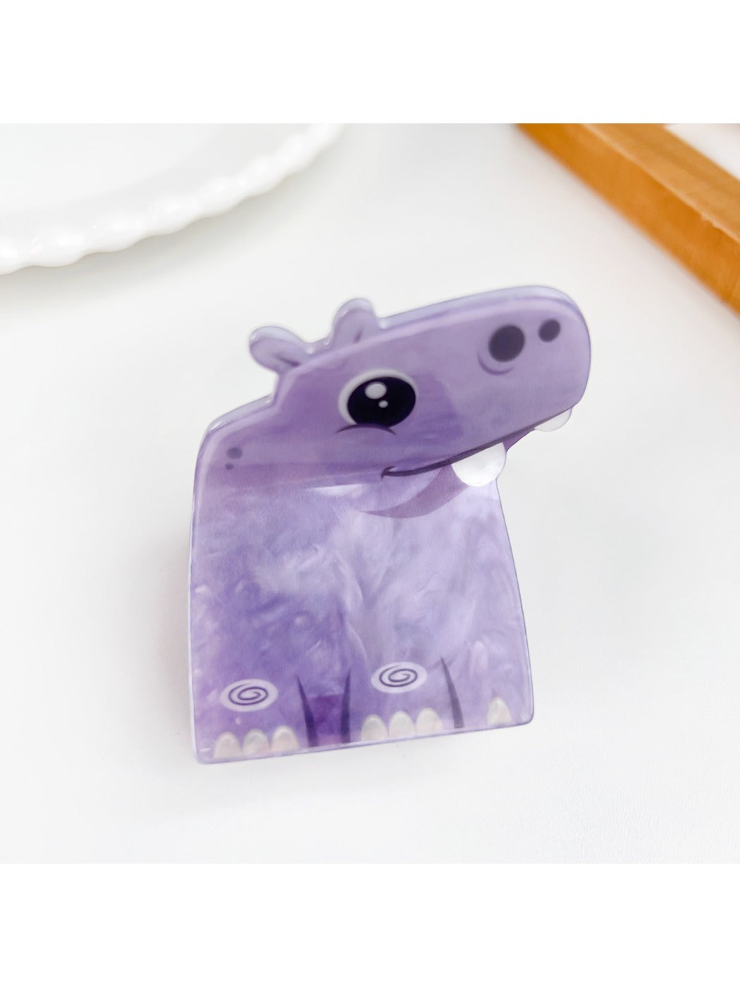 Beau hair claw clip shaped like a cat in matte pink finish on neutral background