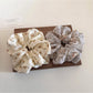Flat lay of Gifty floral print scrunchie on white background highlighting fabric details