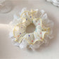 Top view of Gifty polka dot scrunchie emphasizing the ruched fabric detail