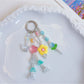 Keypus star and flower charm keychain with gold ring on white background