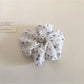 Gifty scrunchie laid flat to display full floral and polka dot design
