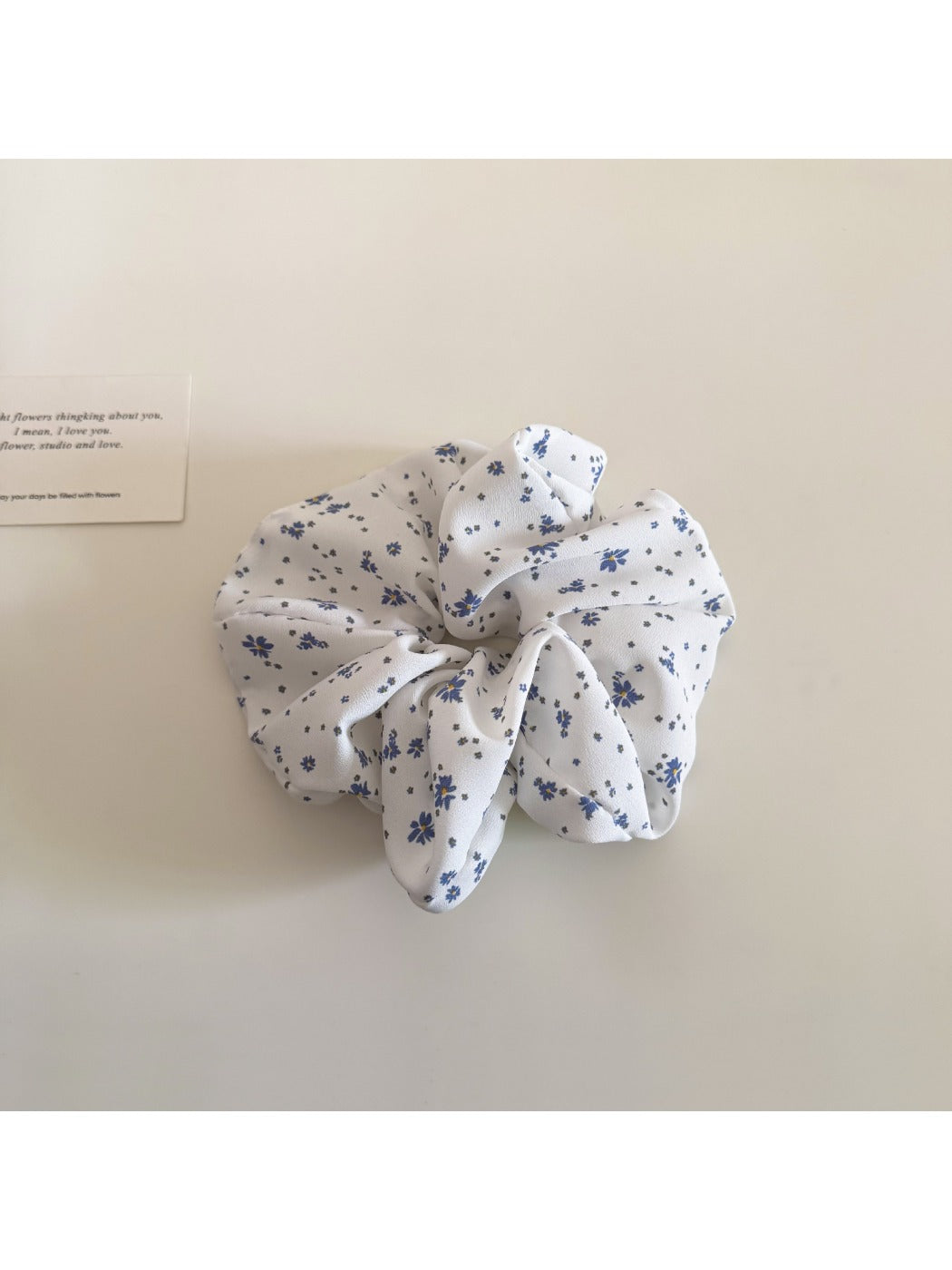 Gifty scrunchie laid flat to display full floral and polka dot design