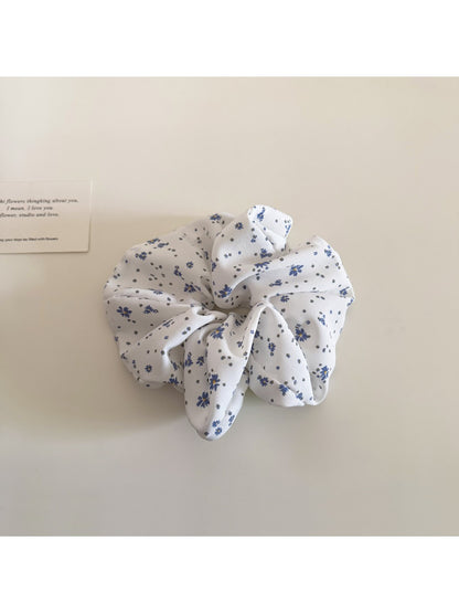 Gifty scrunchie laid flat to display full floral and polka dot design