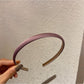 Model styling candy color satin headband with loose hair