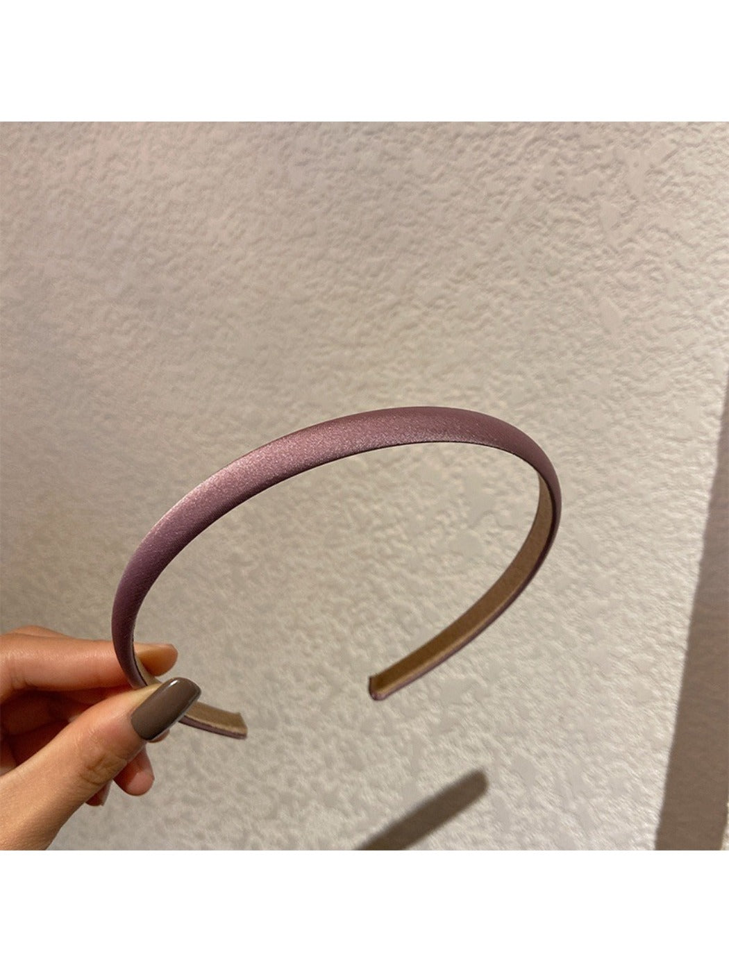 Model styling candy color satin headband with loose hair