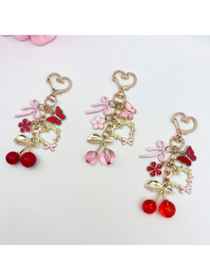 Cherry bow charm keychain with red cherries and a pink bow on a silver keyring
