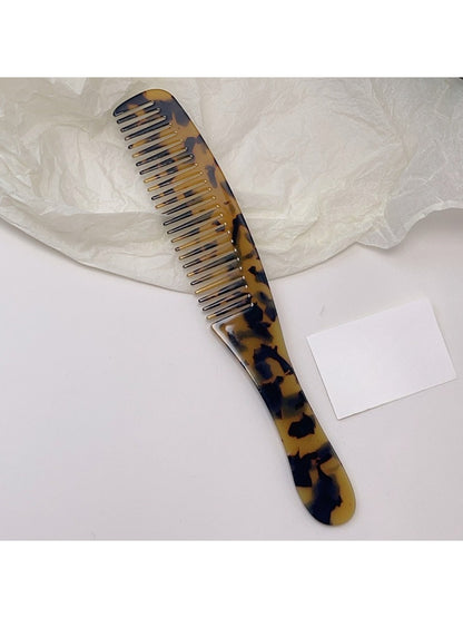 Camerow long handle hair comb resting on a towel in a bathroom setting
