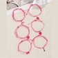 Lovra bracelet with lipstick bow-shaped pendant on woven band