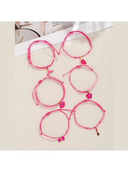 Lovra bracelet with lipstick bow-shaped pendant on woven band
