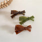Beau hair clip worn in long brown hair styled in loose waves