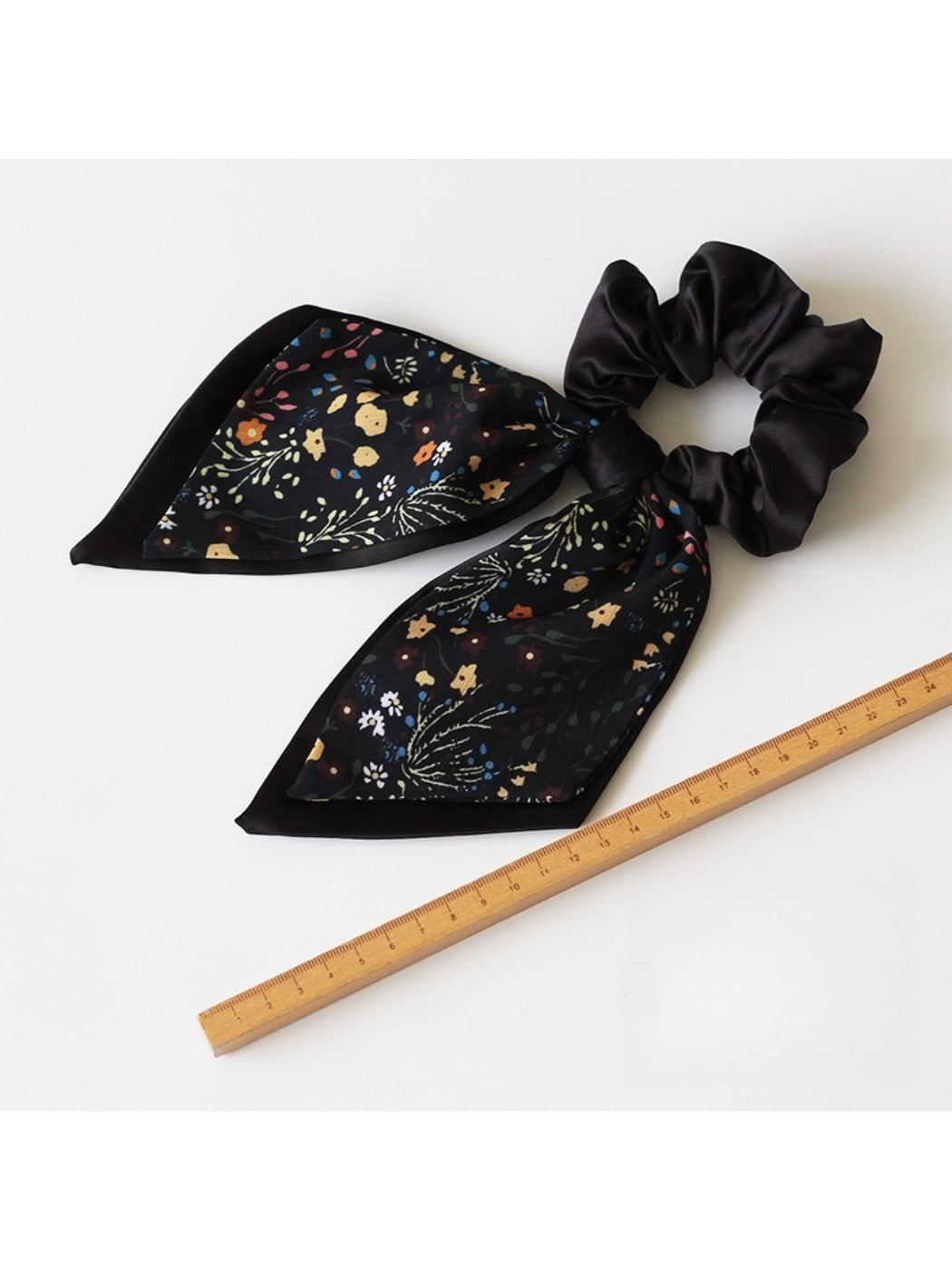 Gifty printed bow hair tie laid flat highlighting bow shape and elastic band