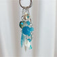 Keychain with minimalist ocean charm displayed on a wooden surface