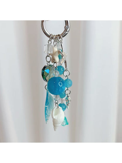 Keychain with minimalist ocean charm displayed on a wooden surface