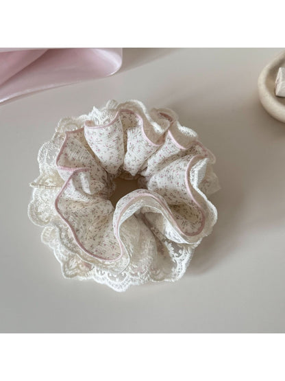 Gifty tiny floral scrunchie wrapped around a wrist as a bracelet