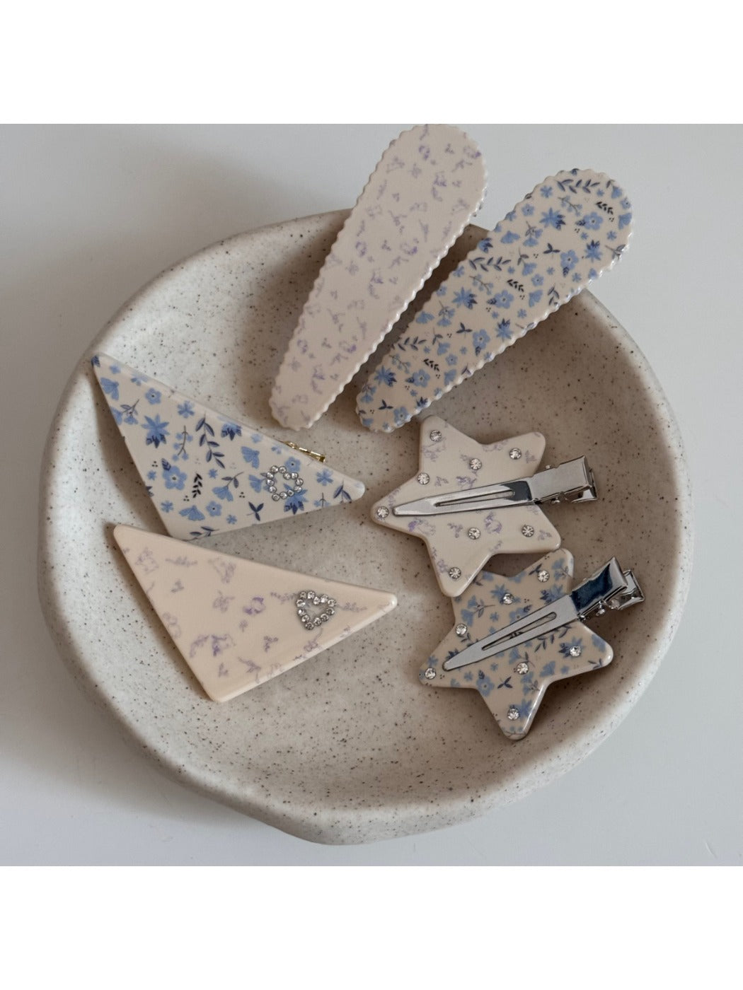 Close-up of Beau triangle star hair clip showing detailed star print and smooth texture