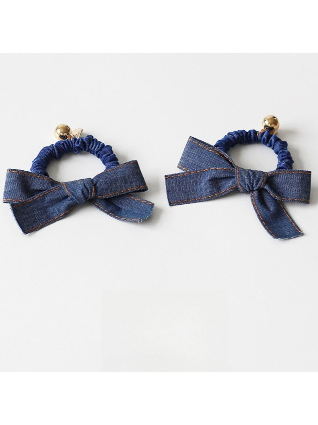 Top view of vintage bow hair tie highlighting bow shape and fabric texture