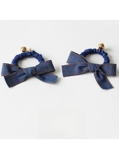 Top view of vintage bow hair tie highlighting bow shape and fabric texture