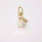 Keypus trendy keychain with multicolored beads and bow charm displayed on a wooden surface