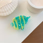 Beau fish shaped claw clip with intricate painted details and smooth finish