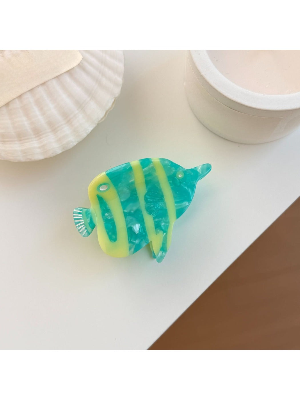 Beau fish shaped claw clip with intricate painted details and smooth finish