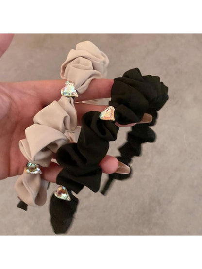 Side view of heart shape rhinestone headband showing metal band and stone details