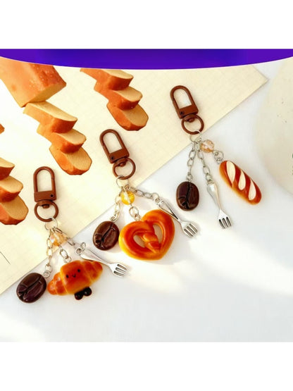 Mini baguette shaped keychain in light brown leather with gold hardware