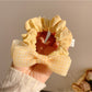 Side view of Gifty sweet bow hair tie showing elastic band and bow