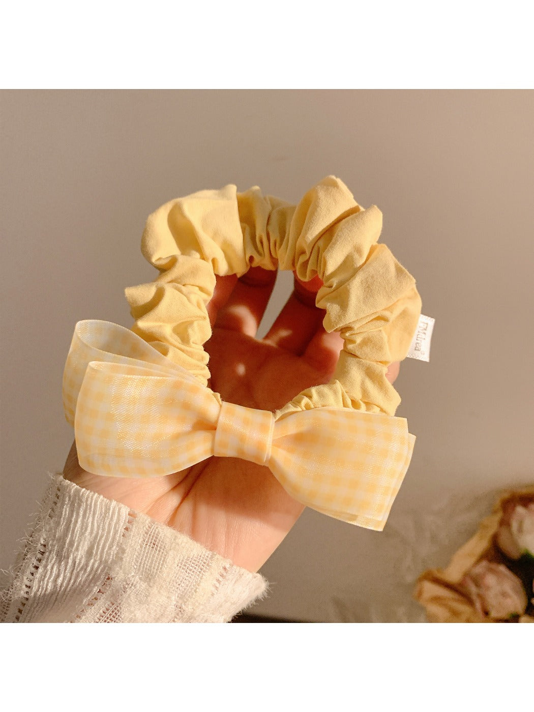 Side view of Gifty sweet bow hair tie showing elastic band and bow