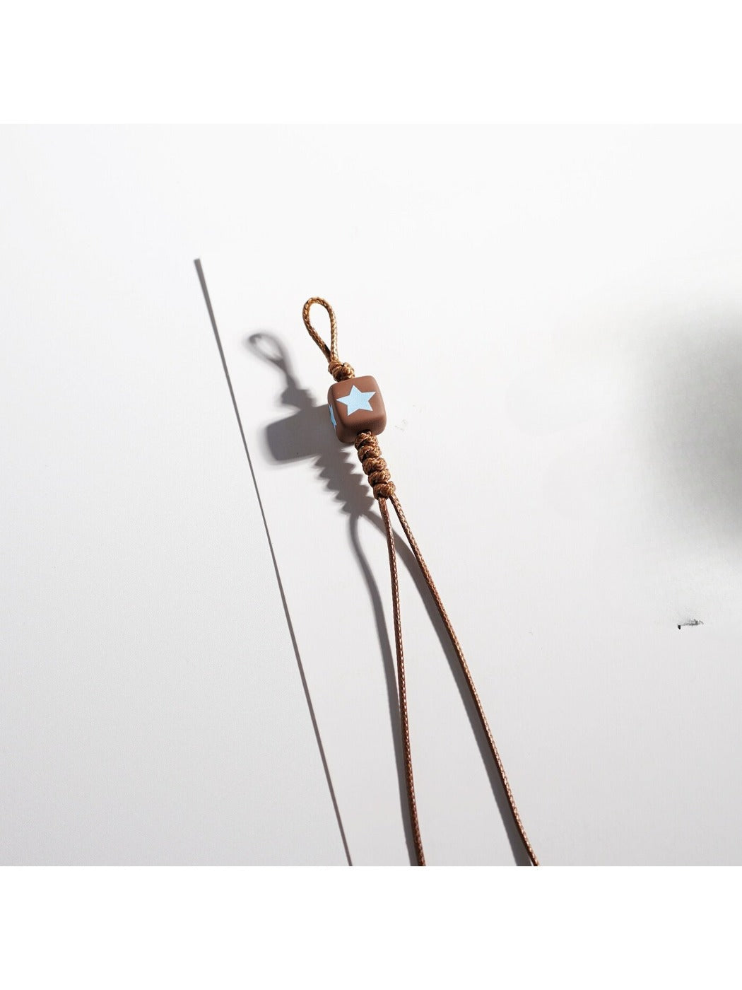 Side view of brown tone cartoon keychain highlighting its thickness
