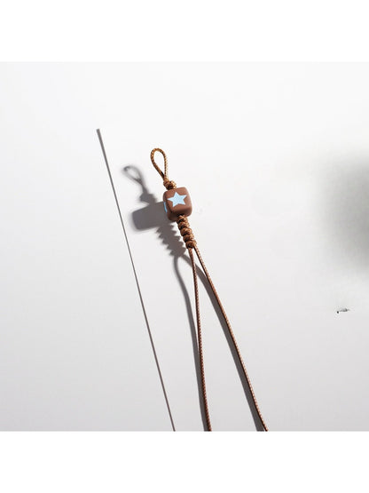 Side view of brown tone cartoon keychain highlighting its thickness