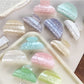 Side view of Beau macaron colored crescent claw clip highlighting curved design