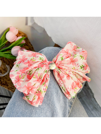Red floral bow scrunchie paired with casual outfit on model