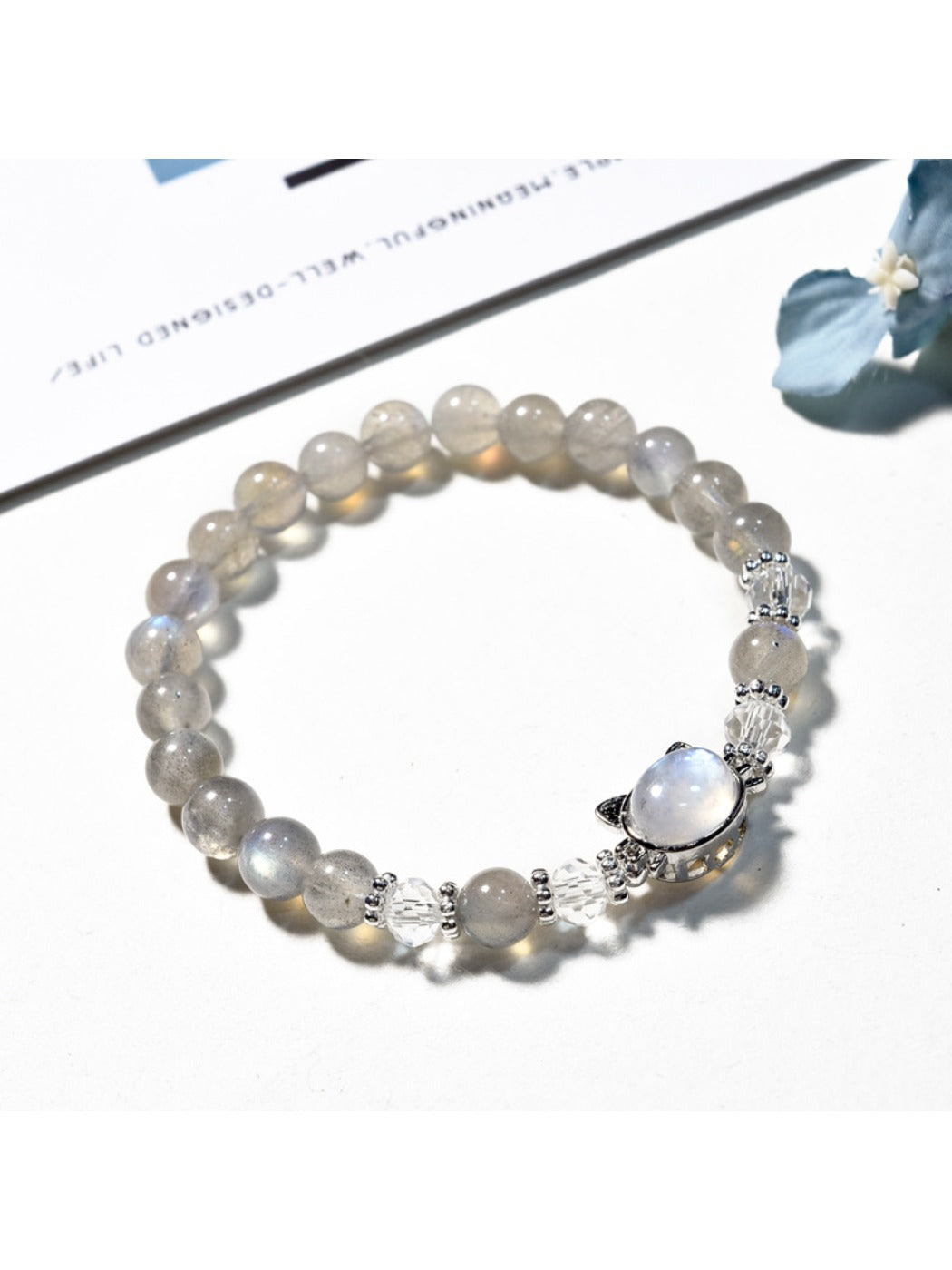 Close-up of Lovra minimalist gray crystal beaded bracelet on a white background