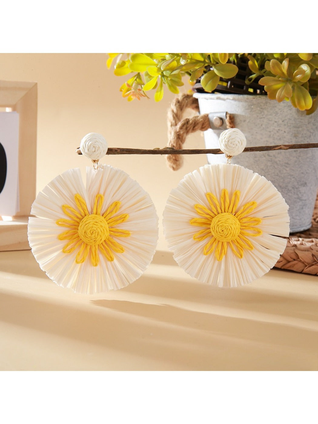 Model wearing color block sunflower shaped earrings with short hair