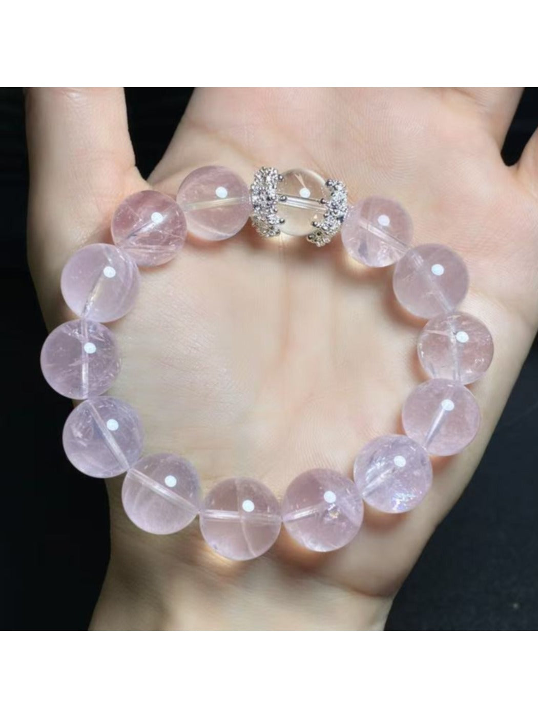 Lovra pink crystal bracelet with reflective beads against a neutral background