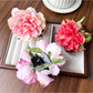 Beau lifelike peony flower claw clip worn in model's hair from side angle