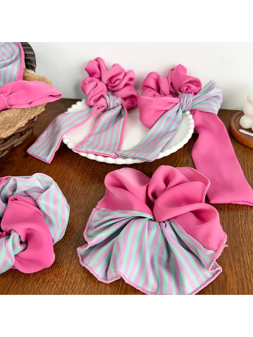 Magenta striped scrunchie styled on a ponytail