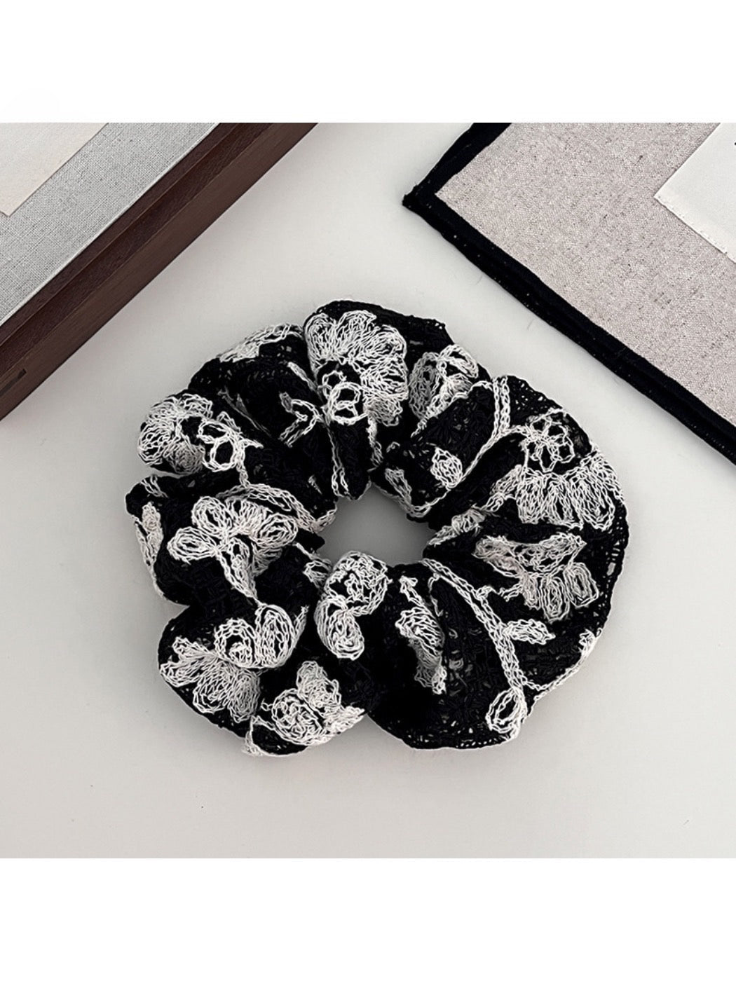 Model wearing Gifty artistic textured surface scrunchie in her hair