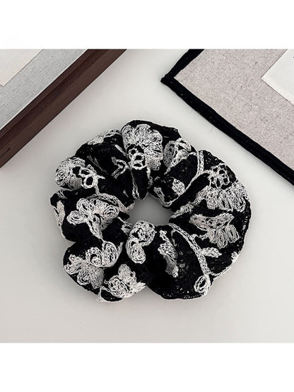 Model wearing Gifty artistic textured surface scrunchie in her hair