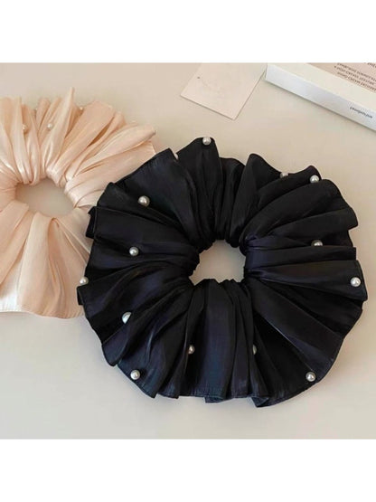 Beige satin scrunchie displayed flat showing its full size and shape