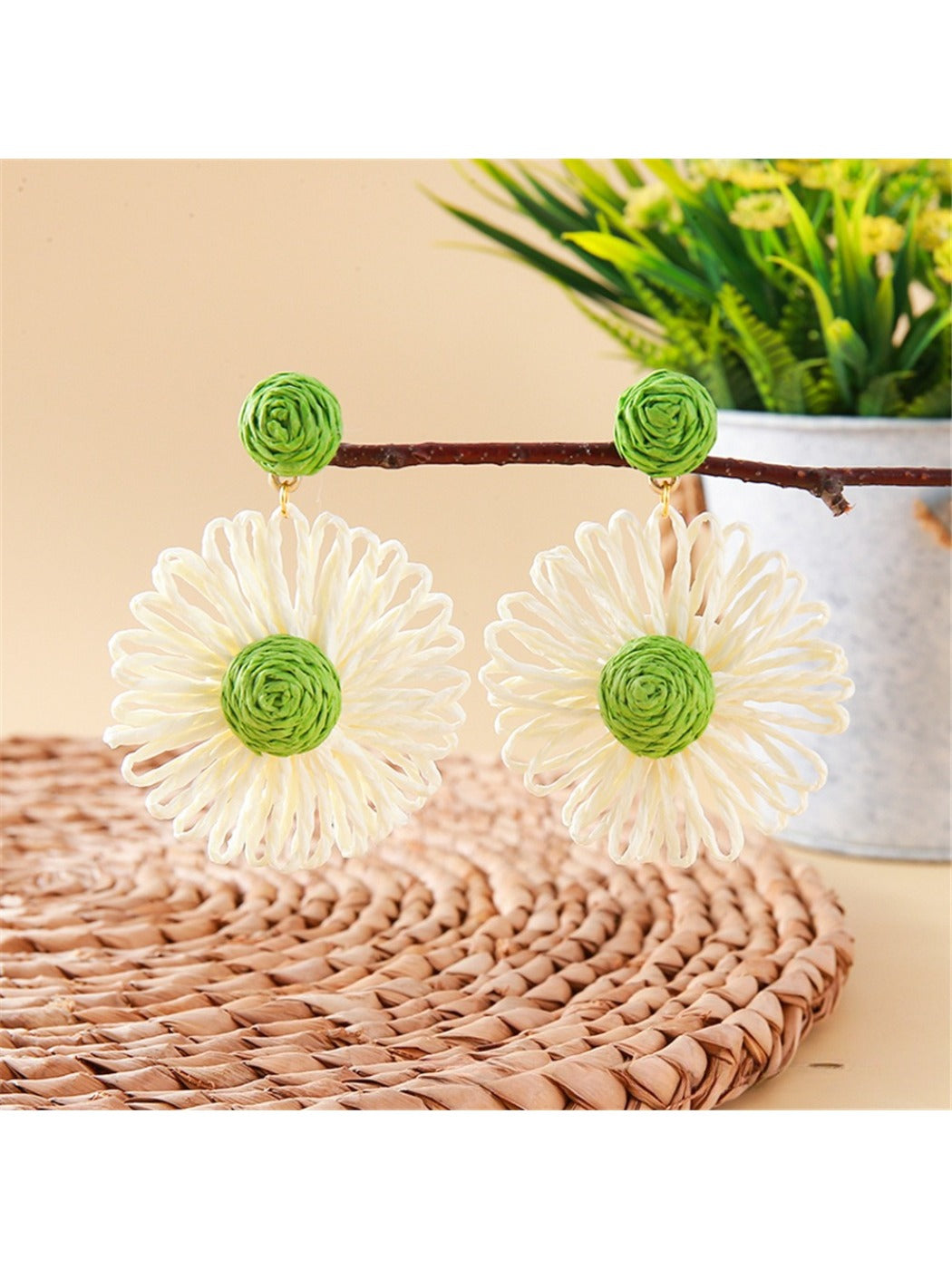 Side view of raffia flower shaped drop earrings showing woven texture