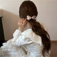 Side view of Gifty printed hair tie with pink bow detail