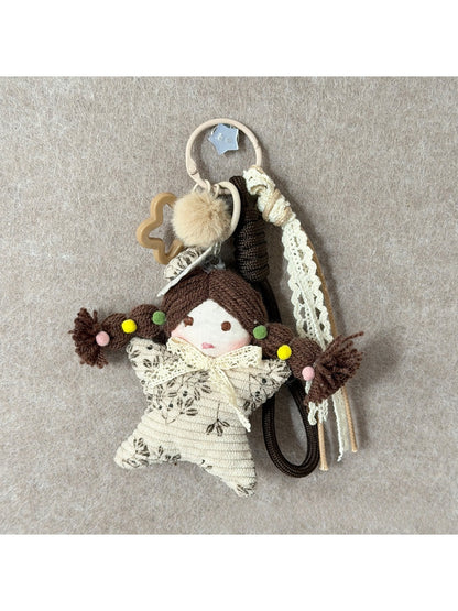 Keypus fabric cartoon doll keychain held in hand to show size and scale